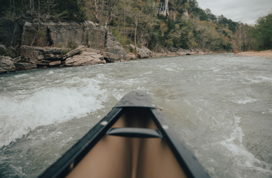 Canoer point of view near soft white waters.