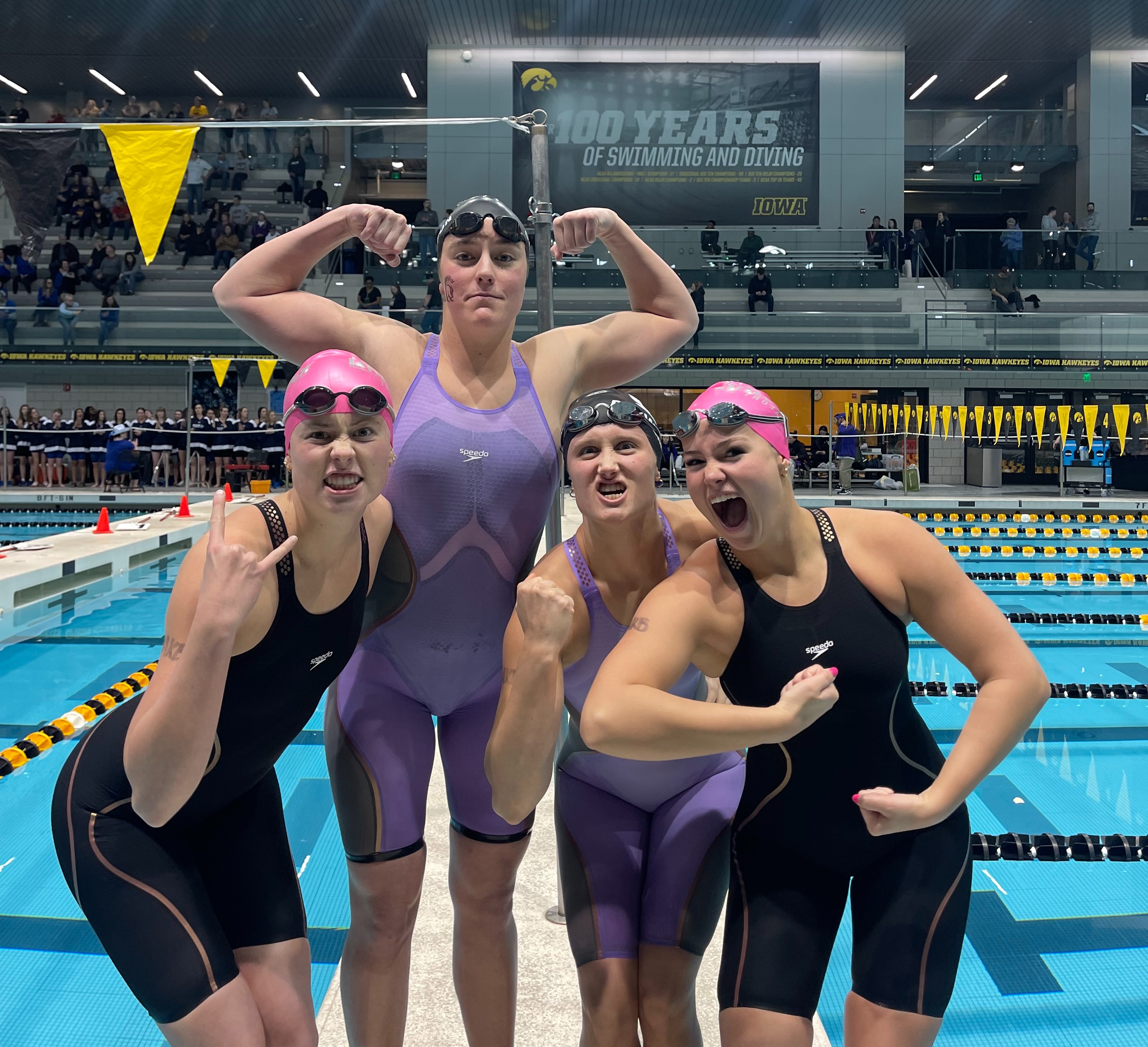 Caitlin, Jaelle, Lauren, Lucy in front of pool flexing