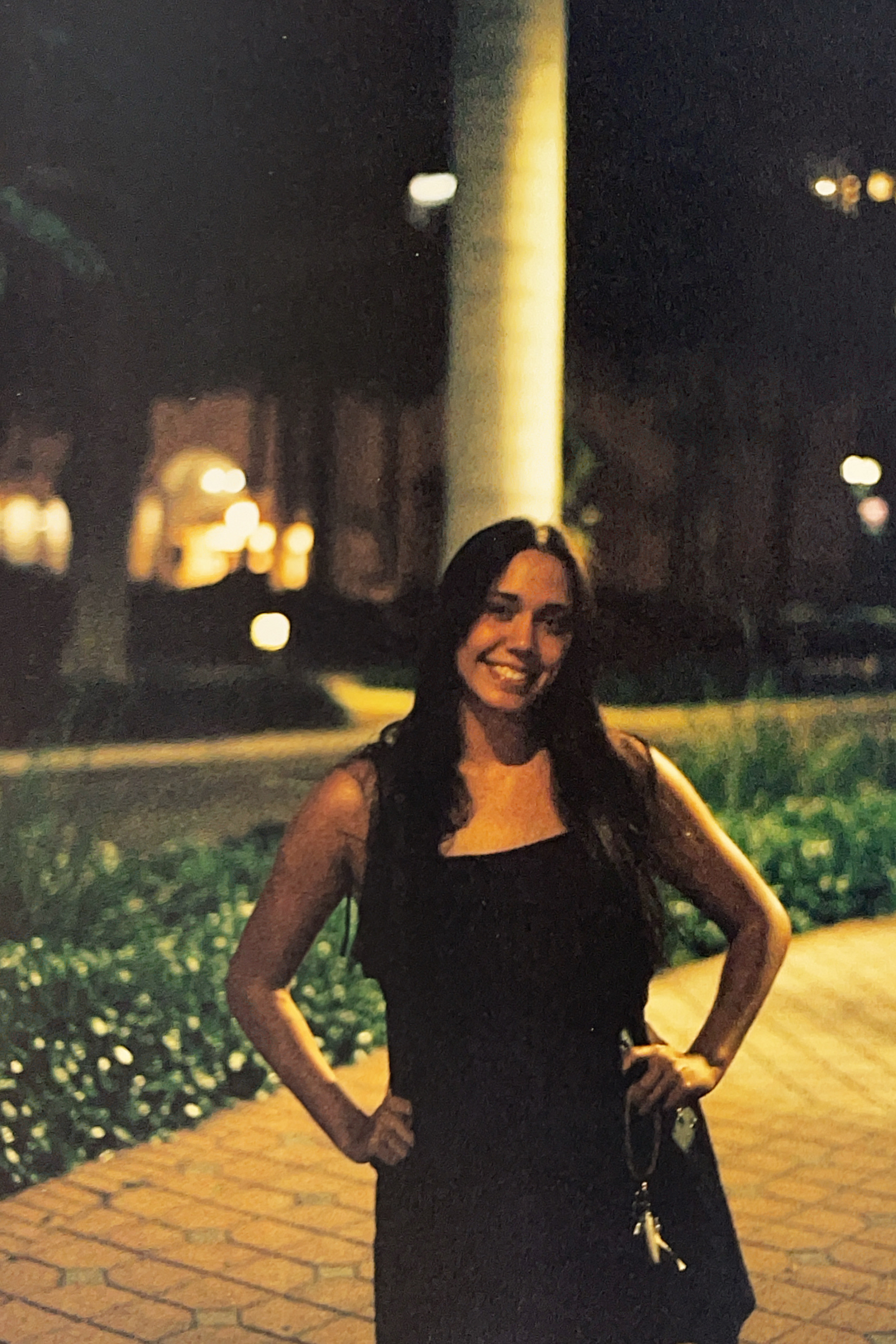 Gillian posing in front of restraunt at night